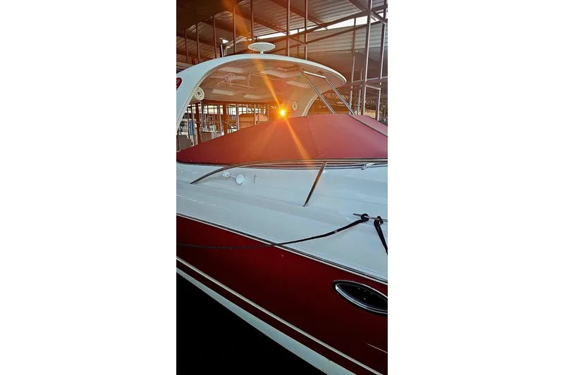 Slide: The Image of 2010 Chaparral Signature 370 boat with red cover in marina at sunset. - 35