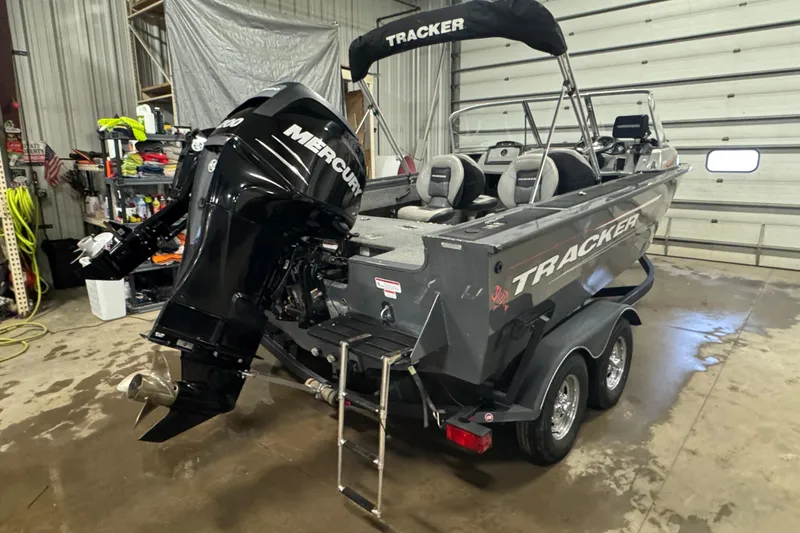 Slide: The Image of 2017 Tracker Targa V-18 WT boat with Mercury engine in a garage setting. - 3