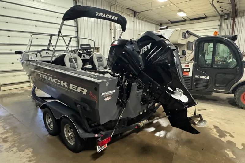 Slide: The Image of 2017 Tracker Targa V-18 WT boat with Mercury engine in a garage setting. - 4