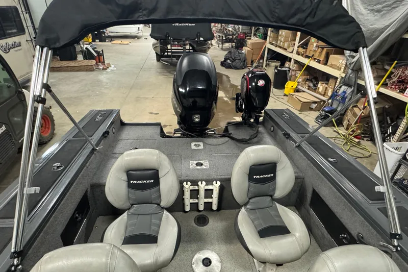 Slide: The Image of 2017 Tracker Targa V-18 WT boat interior with dual engines in a workshop setting. - 9