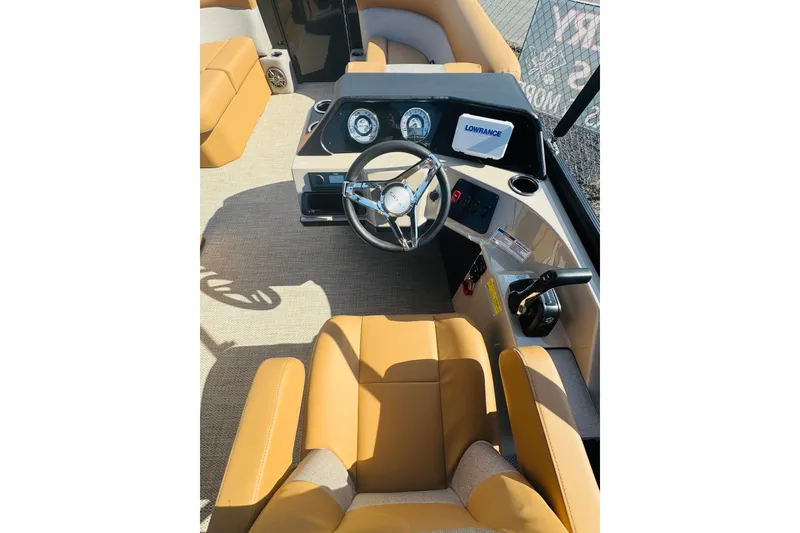 Slide: The Image of 2026 Crest Conquest SE 200 Cruise boat interior with tan seating and modern dashboard. - 11