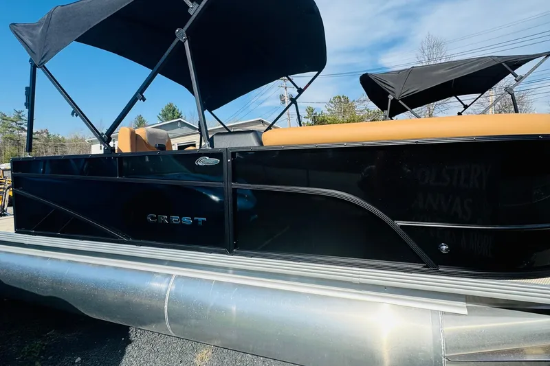 Slide: The Image of 2026 Crest Conquest SE 200 Cruise pontoon boat with black exterior and tan seating. - 4