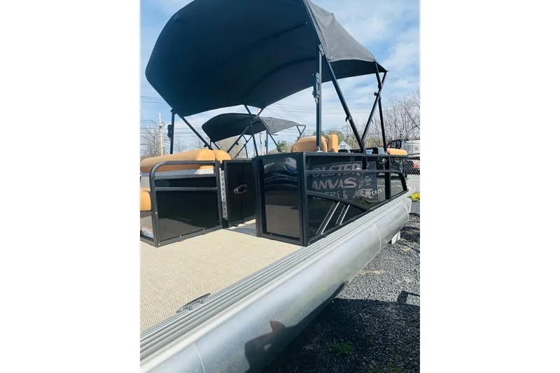 Slide: The Image of 2026 Crest Conquest SE 200 Cruise pontoon boat with canopy and seating, docked outdoors. - 5