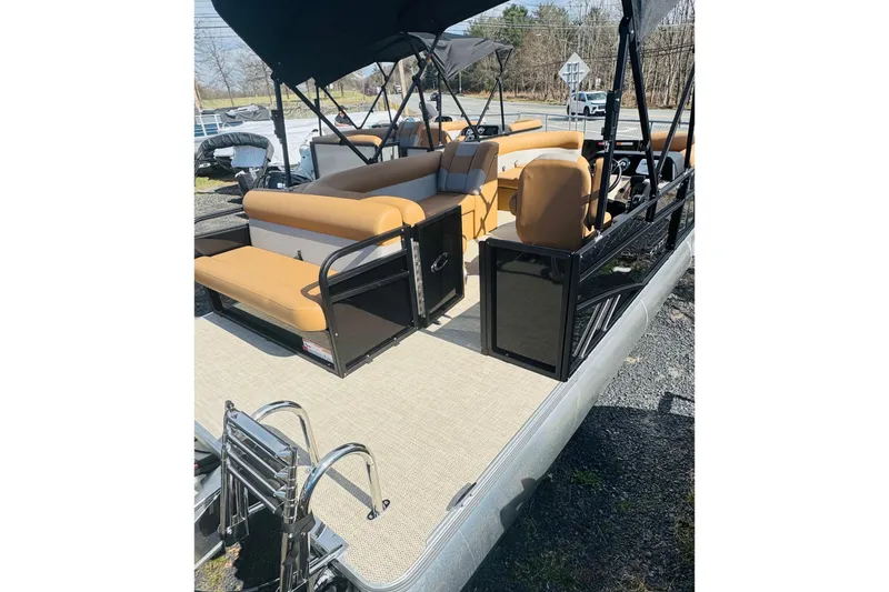 Slide: The Image of 2026 Crest Conquest SE 200 Cruise pontoon boat with tan seating and black railings. - 6