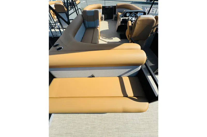 Slide: The Image of 2026 Crest Conquest SE 200 Cruise boat interior with tan seating and steering console. - 7