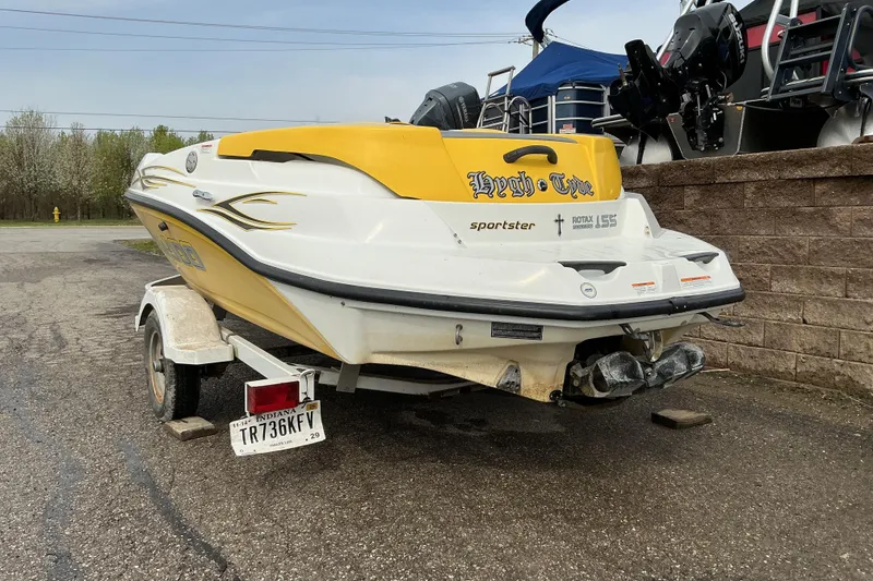 Slide: The Image of 2005 Sea-Doo Sportster boat on trailer, yellow and white design, parked outdoors. - 4