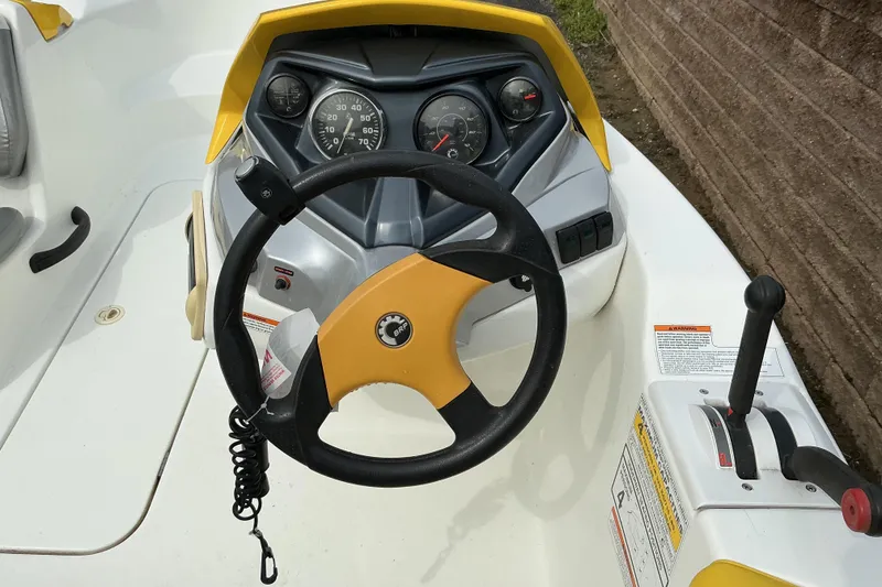 Slide: The Image of 2005 Sea-Doo Sportster dashboard with steering wheel and control panel. - 6