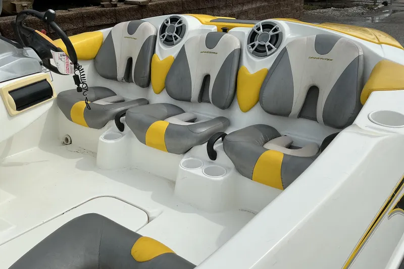 Slide: The Image of 2005 Sea-Doo Sportster boat interior with yellow and gray seating, cup holders, and steering wheel. - 8