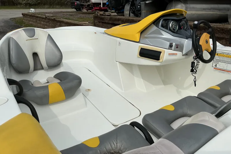 Slide: The Image of 2005 Sea-Doo Sportster boat interior with yellow and gray seating and steering console. - 9