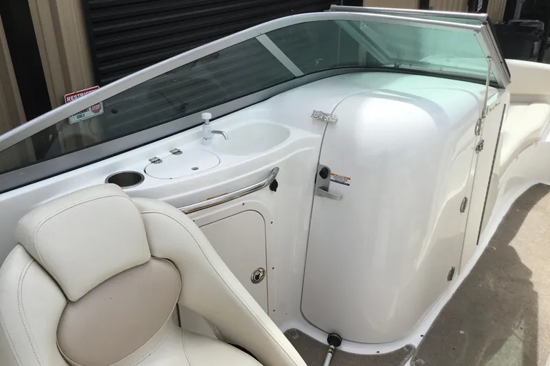 Slide: The Image of 2005 Chaparral Sunesta 216 boat interior with white seating and sink area. - 11