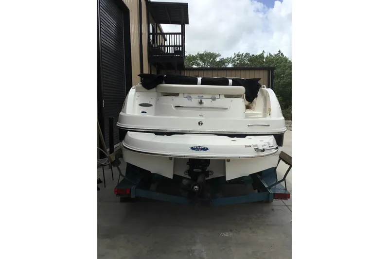 Slide: The Image of 2005 Chaparral Sunesta 216 boat, rear view, parked indoors on a trailer. - 5