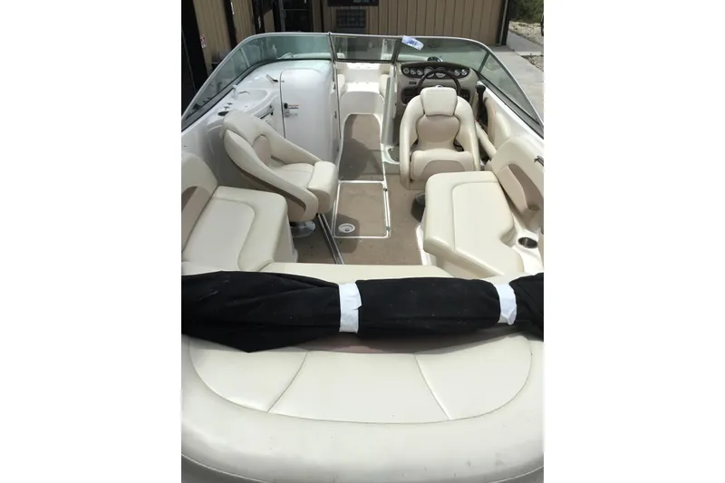 Slide: The Image of 2005 Chaparral Sunesta 216 boat interior with beige seating and steering console. - 7