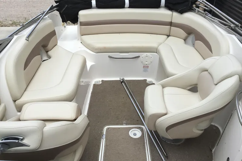Slide: The Image of 2005 Chaparral Sunesta 216 boat interior with beige seating and carpeted floor. - 8