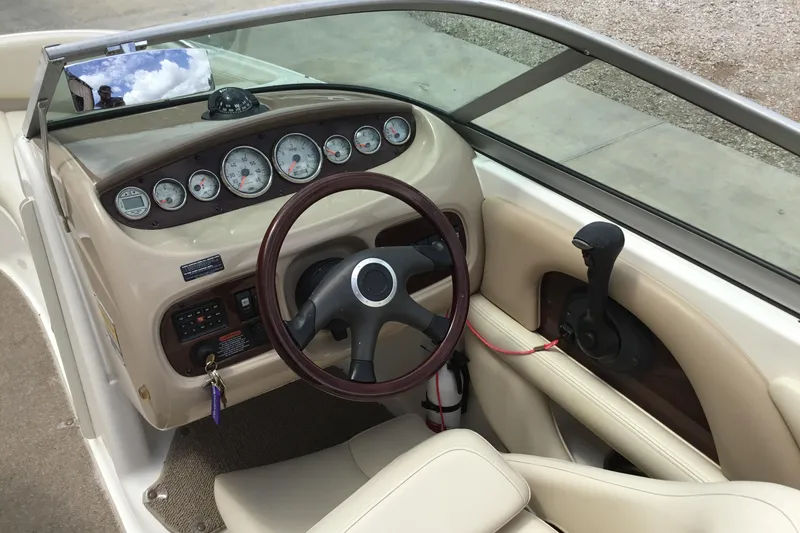 Slide: The Image of 2005 Chaparral Sunesta 216 boat dashboard with steering wheel and control panel. - 9