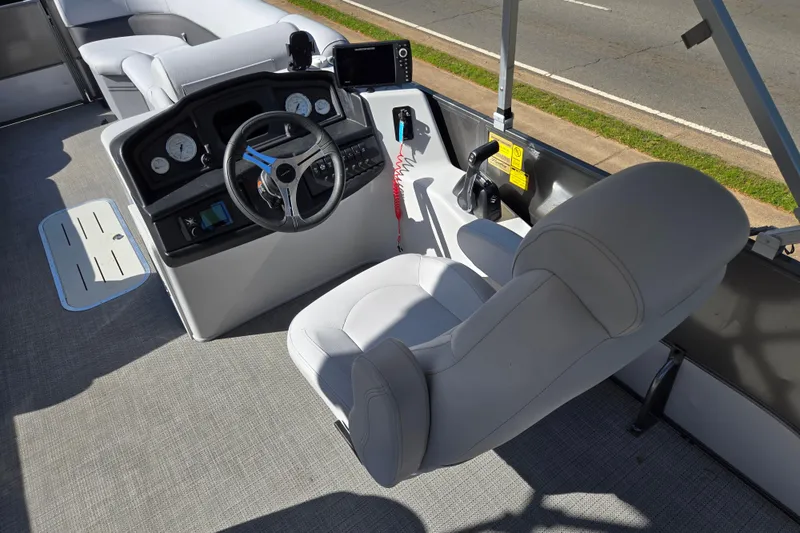 Slide: The Image of Interior of 2022 Bentley Pontoons 240 Cruise XL, featuring steering console and seating. - 11