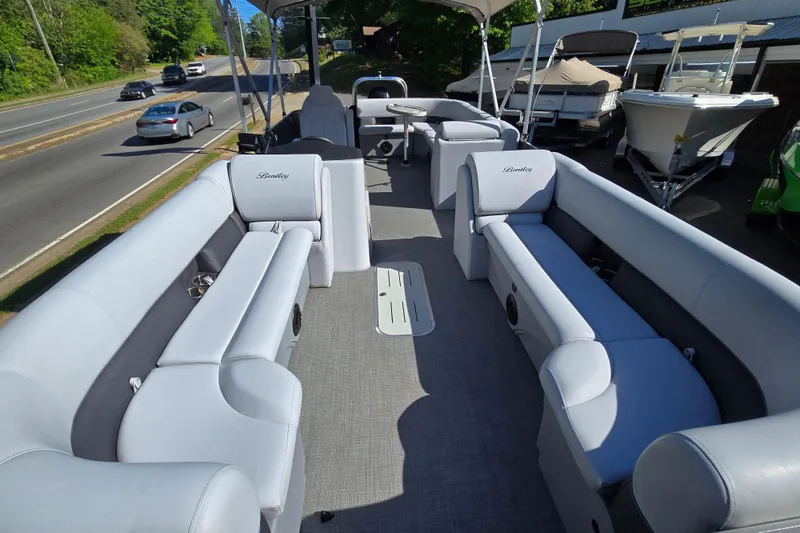 Slide: The Image of 2022 Bentley Pontoons 240 Cruise XL Legacy with spacious seating, parked near a road. - 13