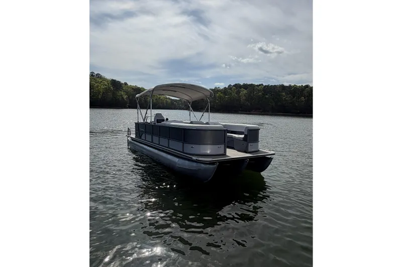 Slide: The Image of 2022 Bentley Pontoons 240 Cruise XL Legacy on a serene lake. - 3