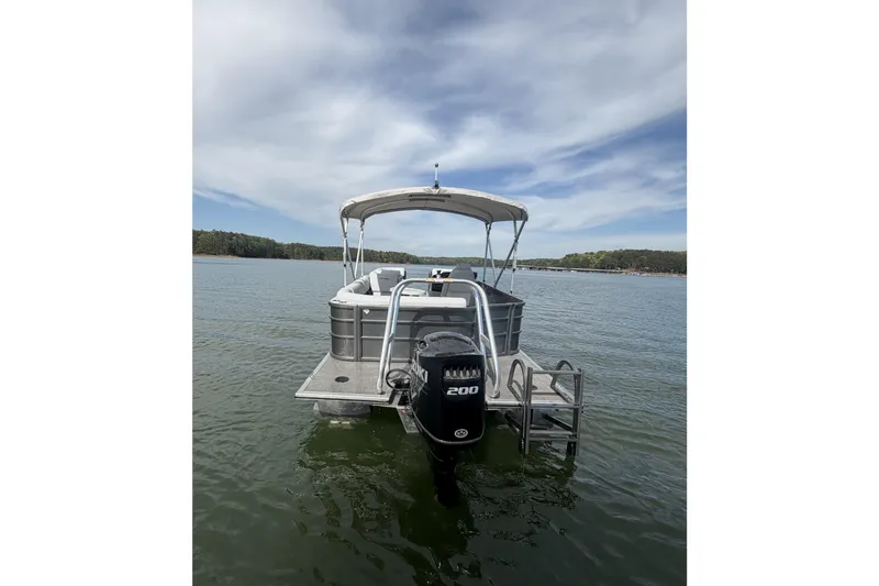 Slide: The Image of 2022 Bentley Pontoons 240 Cruise XL on water, featuring 200hp engine, under clear sky. - 5