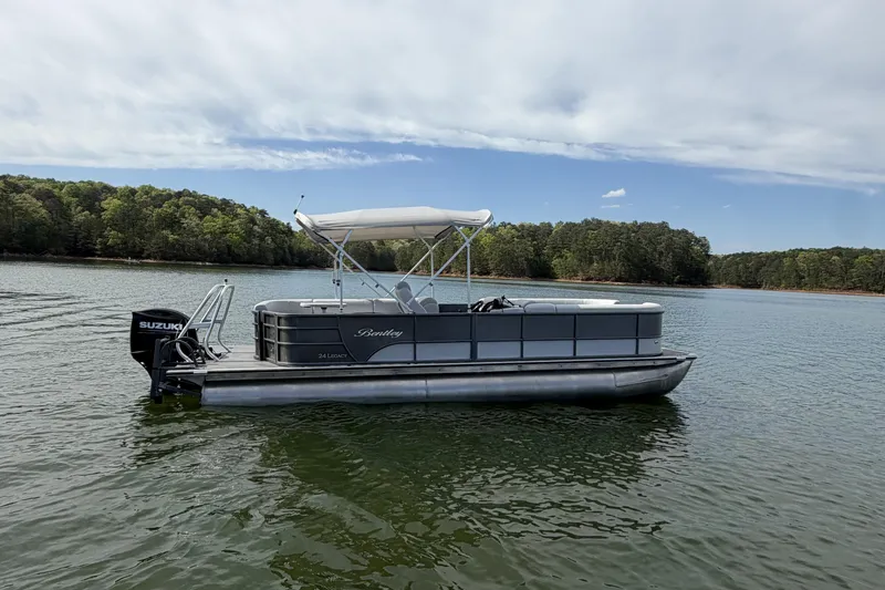 Slide: The Image of 2022 Bentley Pontoons 240 Cruise XL Legacy on a serene lake. - 8