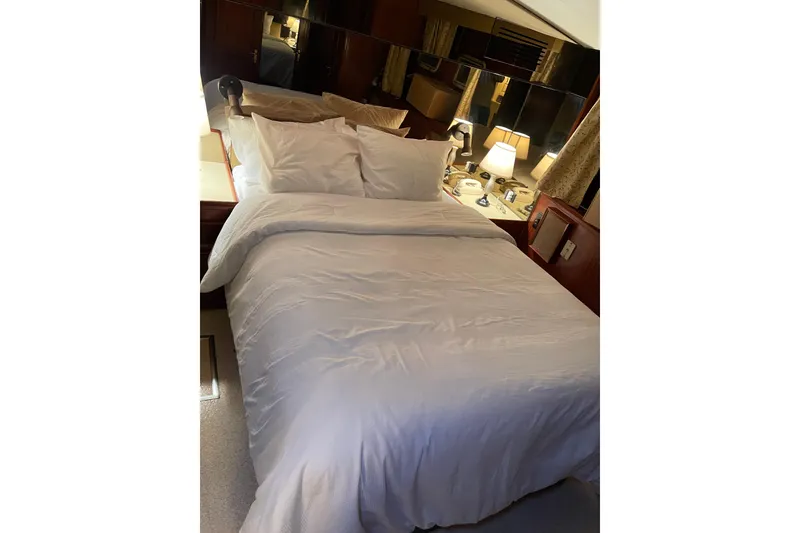 Slide: The Image of Luxurious bedroom interior of 1985 Hatteras 60 Convertible yacht with cozy bedding. - 19