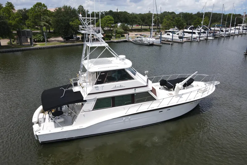 Slide: The Image of 1985 Hatteras 60 Convertible yacht docked, side view. - 3
