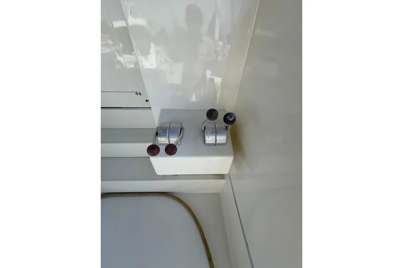 Slide: The Image of Control levers on a 1985 Hatteras 60 Convertible yacht dashboard. - 33