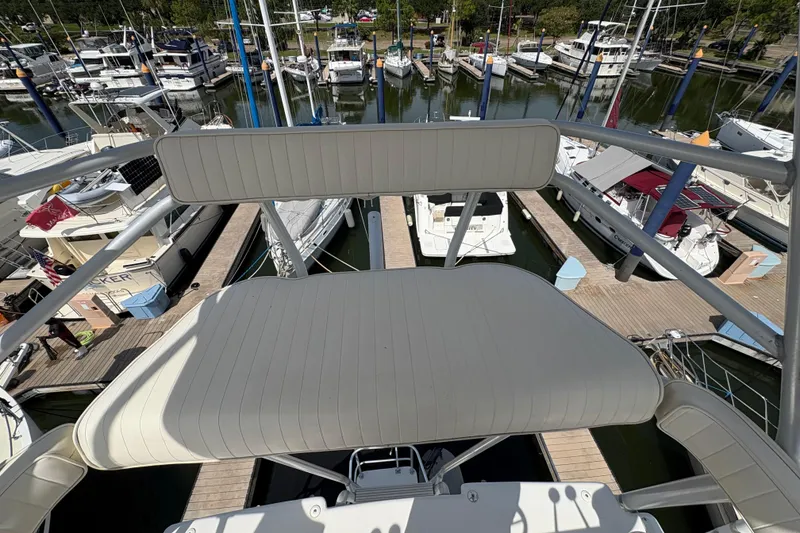 Slide: The Image of View from the flybridge of a 1985 Hatteras 60 Convertible yacht in a marina. - 35