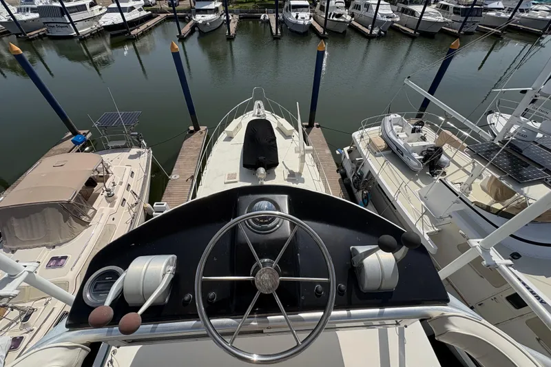 Slide: The Image of 1985 Hatteras 60 Convertible yacht docked at marina, view from helm. - 36