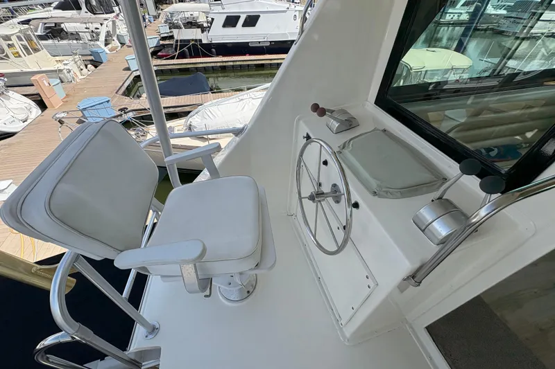 Slide: The Image of Cockpit of 1985 Hatteras 60 Convertible yacht with steering wheel and captain's chair. - 38
