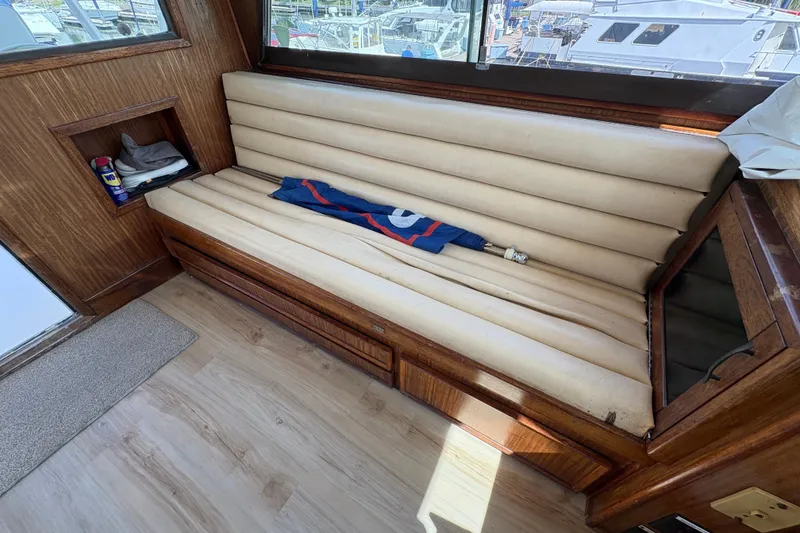 Slide: The Image of 1985 Hatteras 60 Convertible interior with beige leather seating and wooden accents. - 39