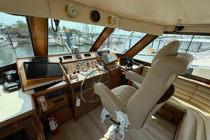 Slide: The Image of Helm of 1985 Hatteras 60 Convertible yacht with navigation equipment and captain's chair. - 41