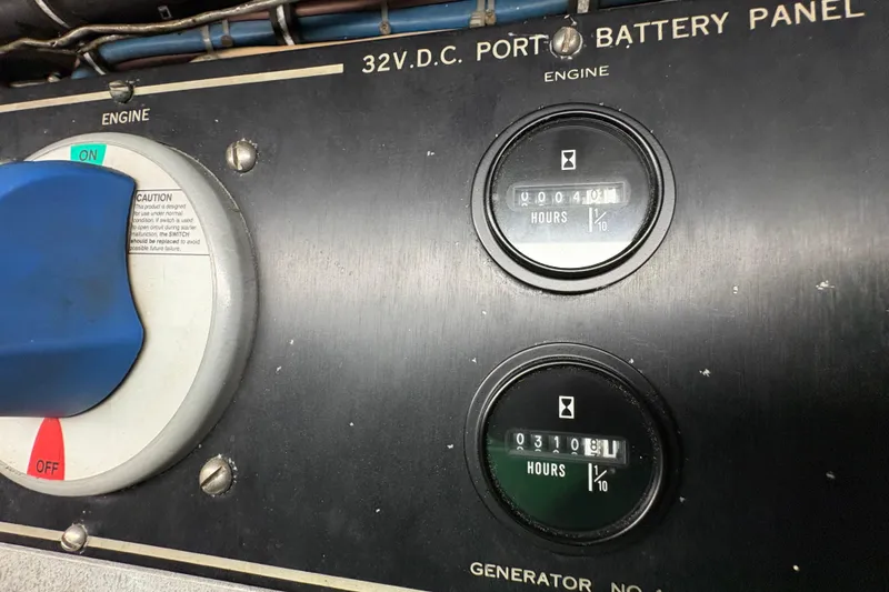 Slide: The Image of Control panel of a 1985 Hatteras 60 Convertible boat, showing engine and generator hours. - 44