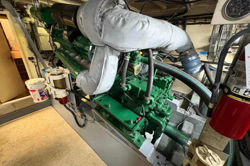 Slide: The Image of Engine room of a 1985 Hatteras 60 Convertible yacht, showcasing machinery and equipment. - 45