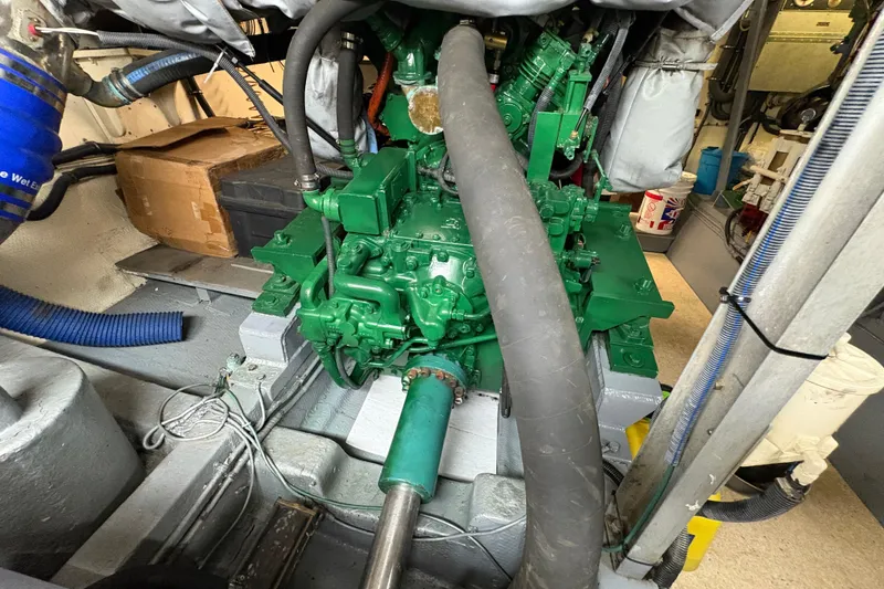 Slide: The Image of Engine room of a 1985 Hatteras 60 Convertible yacht, showcasing green machinery and components. - 46