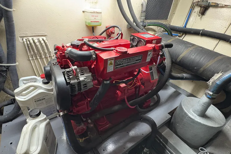 Slide: The Image of Engine room of 1985 Hatteras 60 Convertible with red Westerbeke generator. - 47