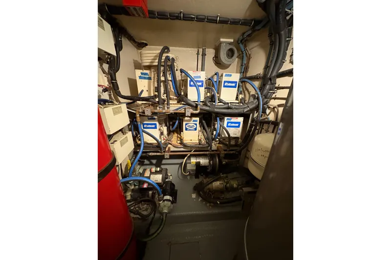 Slide: The Image of Engine room of 1985 Hatteras 60 Convertible yacht with complex wiring and machinery. - 56