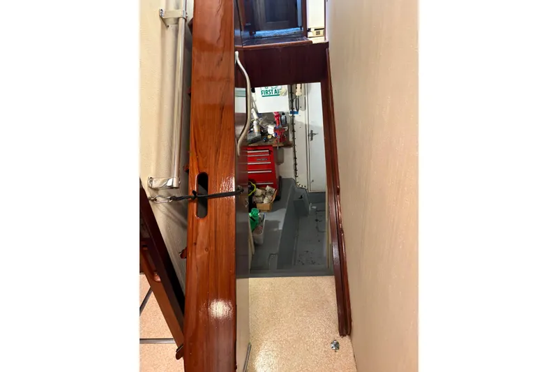 Slide: The Image of Interior view of 1985 Hatteras 60 Convertible yacht, featuring polished wood and storage area. - 58