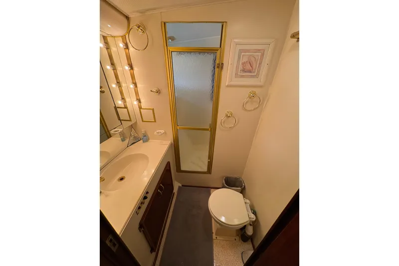 Slide: The Image of Bathroom interior of 1985 Hatteras 60 Convertible yacht, featuring vanity and shower. - 61