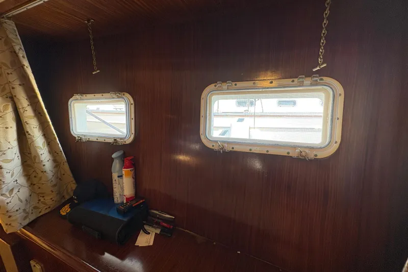 Slide: The Image of Interior of 1985 Hatteras 60 Convertible yacht with portholes and wooden paneling. - 63