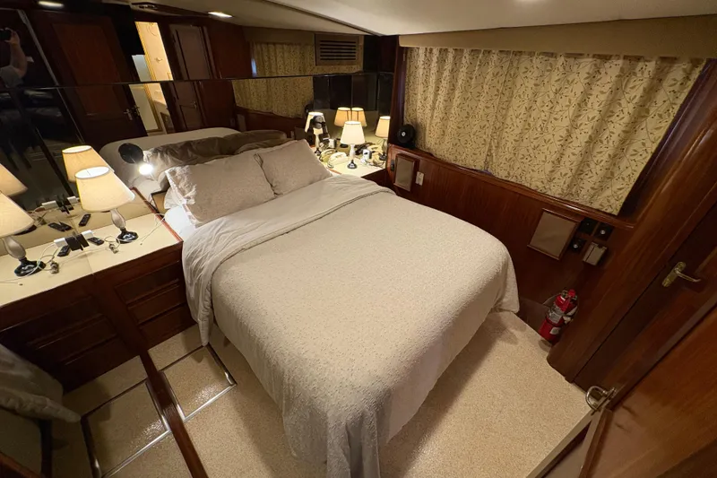 Slide: The Image of Luxurious bedroom interior of 1985 Hatteras 60 Convertible yacht with elegant decor. - 65