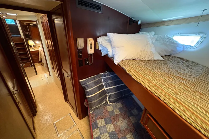 Slide: The Image of Interior cabin of 1985 Hatteras 60 Convertible yacht with bunk beds and cozy decor. - 67