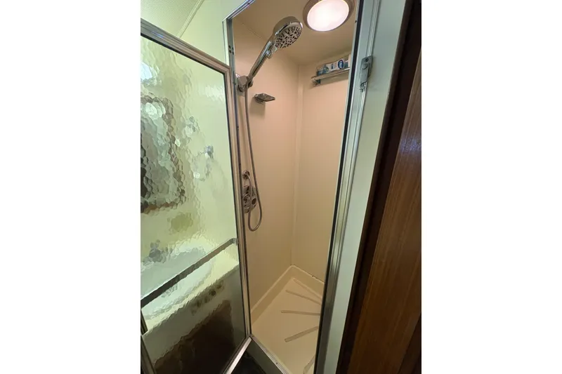 Slide: The Image of Shower area in 1985 Hatteras 60 Convertible yacht with glass door and modern fixtures. - 68