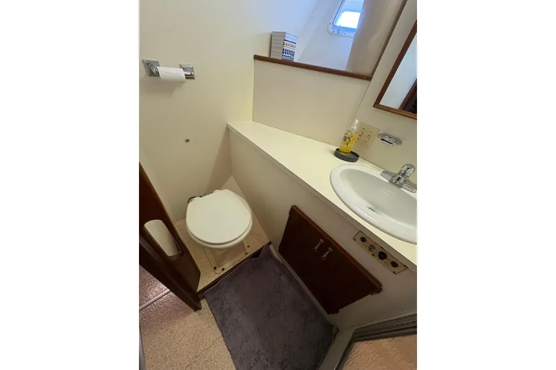 Slide: The Image of Bathroom interior of 1985 Hatteras 60 Convertible yacht, featuring sink and toilet. - 69