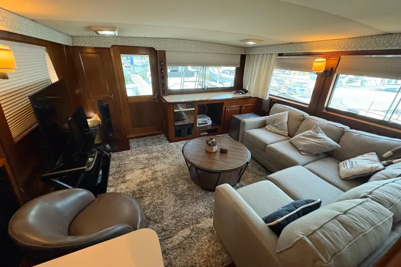 Slide: The Image of Luxurious interior of 1985 Hatteras 60 Convertible yacht with cozy seating and elegant decor. - 75