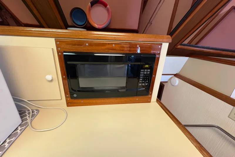 Slide: The Image of Built-in microwave in 1985 Hatteras 60 Convertible yacht kitchen area. - 76