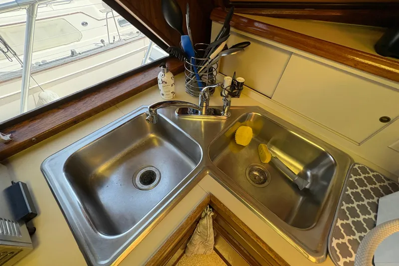 Slide: The Image of Dual stainless steel sinks in 1985 Hatteras 60 Convertible yacht kitchen. - 77