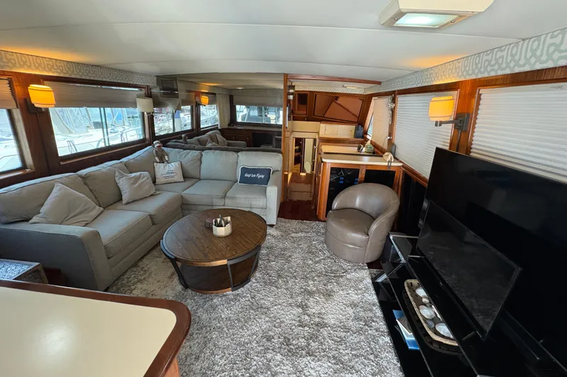 Slide: The Image of Luxurious interior of a 1985 Hatteras 60 Convertible yacht with plush seating and modern decor. - 78