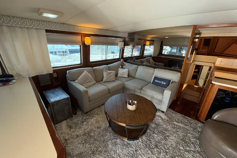 Slide: The Image of Luxurious interior of a 1985 Hatteras 60 Convertible yacht with cozy seating and elegant decor. - 83