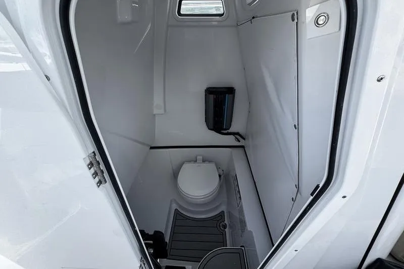 Slide: The Image of Interior of 2026 Sportsman Heritage 261 Center Console boat's compact bathroom. - 10