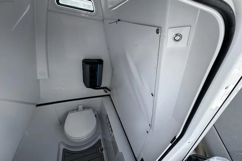 Slide: The Image of Interior of 2026 Sportsman Heritage 261 Center Console boat's compact bathroom. - 12